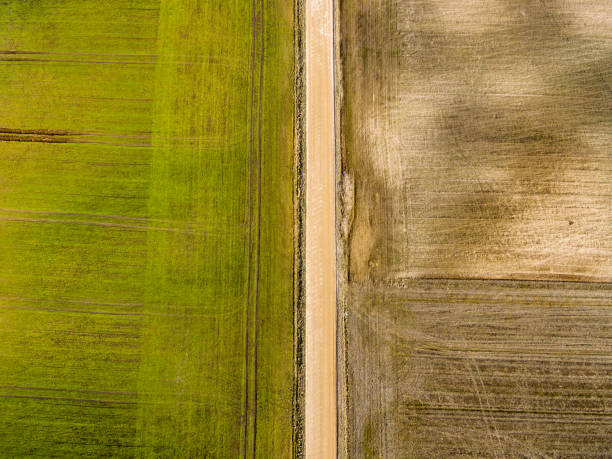 istock drone image. aerial view of rural area with freshly green fields 674729950
