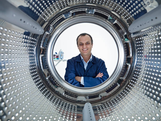 repairman repairman repairing a washing machine washing machine drum stock pictures, royalty-free photos & images