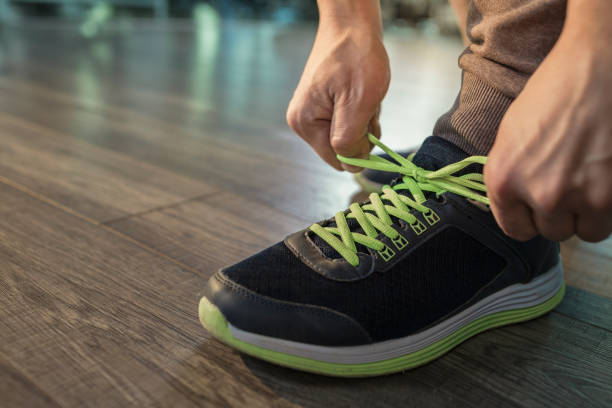 istock Man tying shoelace at gym 674730626
