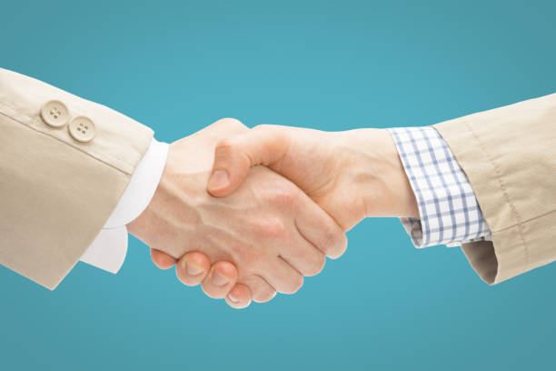 istock Two business men shaking hands - close up studio shot 674730926