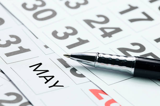 istock MAY text in calendar with pen. month and calendar concept 674731022