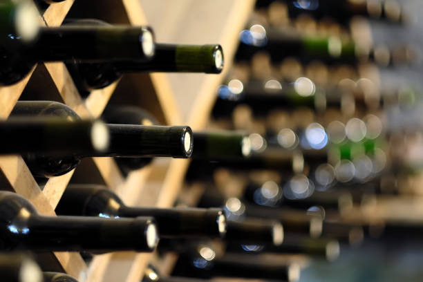 istock Wine bottles stacked on wooden racks 674731160