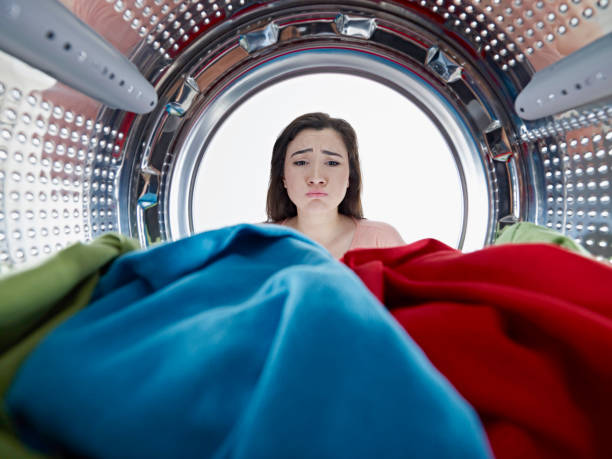 istock unhappy housewife washing laundry 674733590