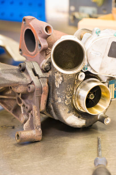 istock Part of a car turbocharger on a workbench with screwdriver 674736126
