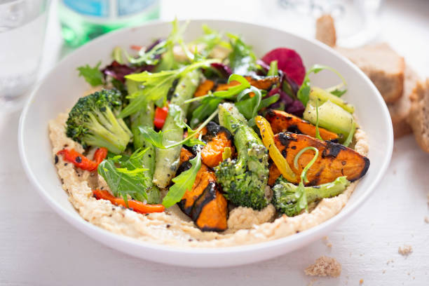 istock Hummus with roasted vegetables and salad 674743360