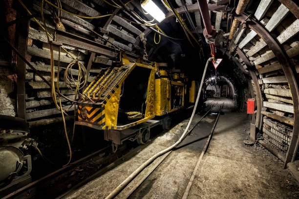 istock Coal mine underground corridor with railway carriages 674743744