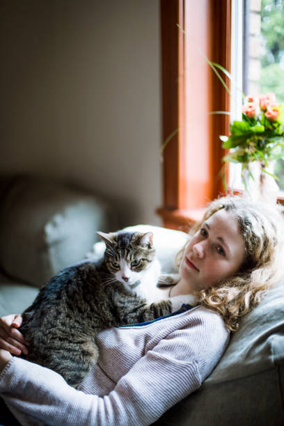 istock A girl and a cat together on a sofa 674743772