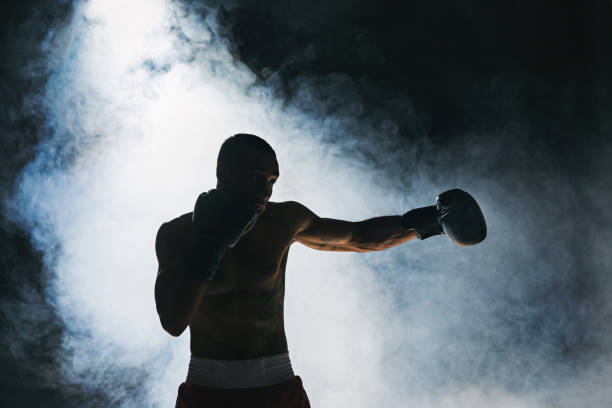 Afro american male boxer Afro american male boxer. Young man boxing workout in a fitness club. Muscular strong man on background black studio combat sport photos stock pictures, royalty-free photos & images