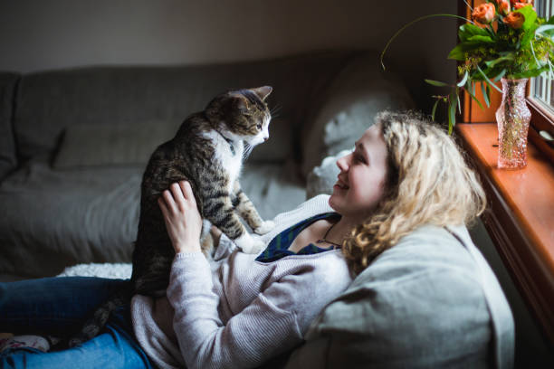 istock A girl and a cat together on a sofa 674744472