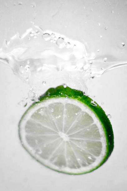 istock Hey fresh and cool lime fruites jumping in cold water. 674744512