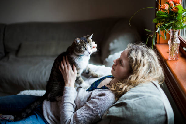 istock A girl and a cat together on a sofa 674746898