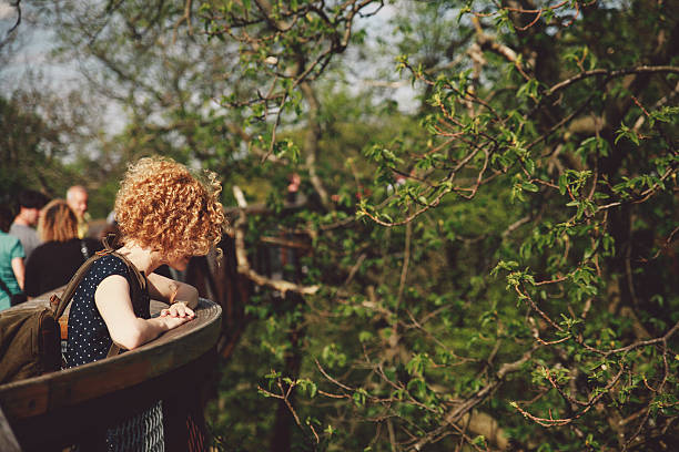 istock Side View Of Woman Standing By Trees At Park 674750045