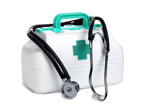 This is a photo of a white medicine kit with a Blue cross on it and a stethoscope. There is a clipping path included with this file. This image symbolizes healthcare.