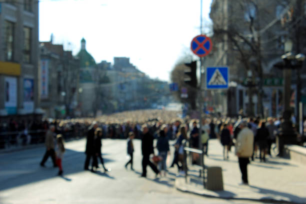 istock Anonymous crowd of people walking through crosswalk 674756084