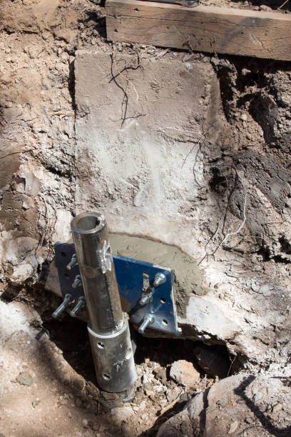 istock Helical pier to jack up a sinking foundation 674760190