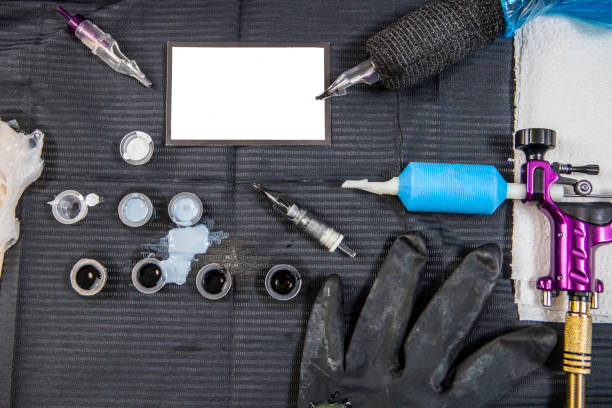 istock Tattoo artist table with objects and empty business card in the middle 674762652