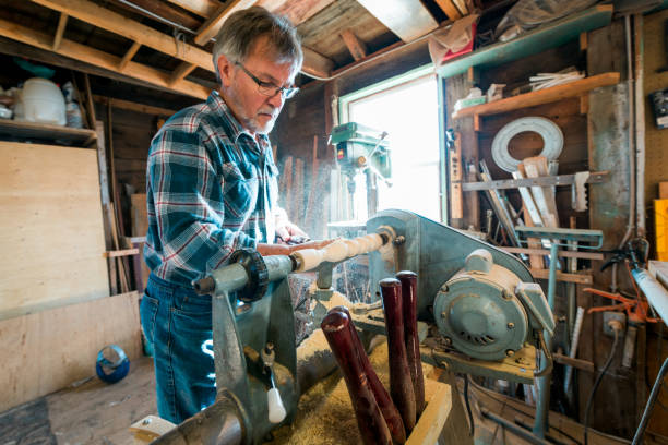 istock Carpenter, Woodworker working with electric lathe in his workshop 674765742