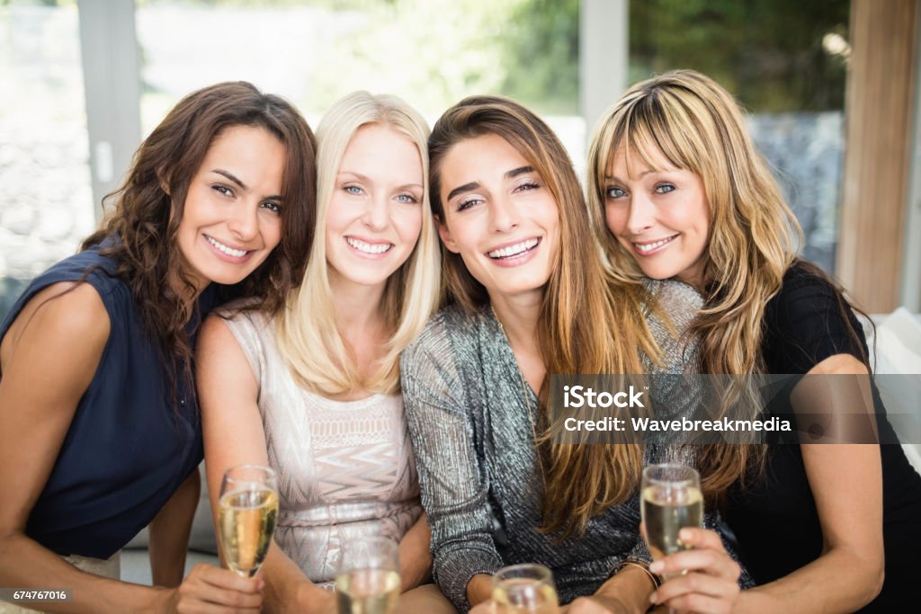 Portrait of beautiful women having drinks Portrait of beautiful women smiling and having drinks at the party Beauty Stock Photo