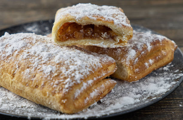 istock Delicious puff pastry with apples on a wooden background 674769934
