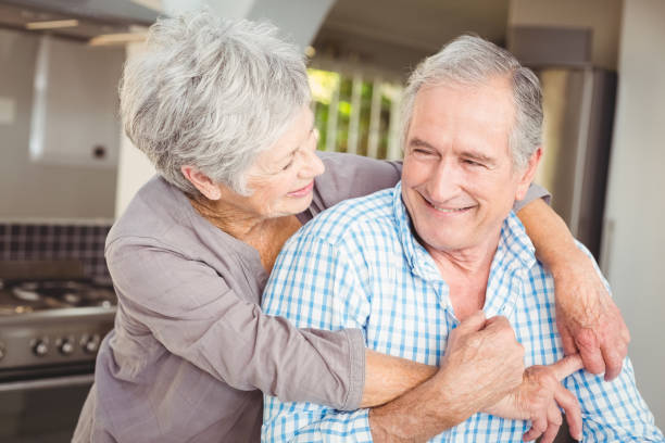 istock Cheerful senior couple embracing in kitchen 674775100