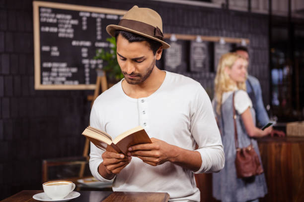 man reading a book - job search newspaper coffee shop cafe imagens e fotografias de stock