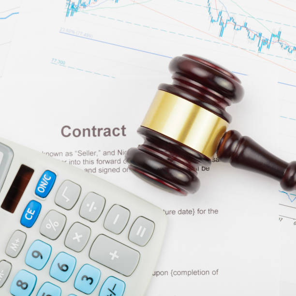 istock Wooden judge's gavel and calculator over some documents - close up studio shot 674778684