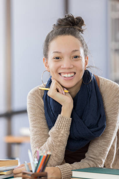 istock Pretty female college student in the library 674778968