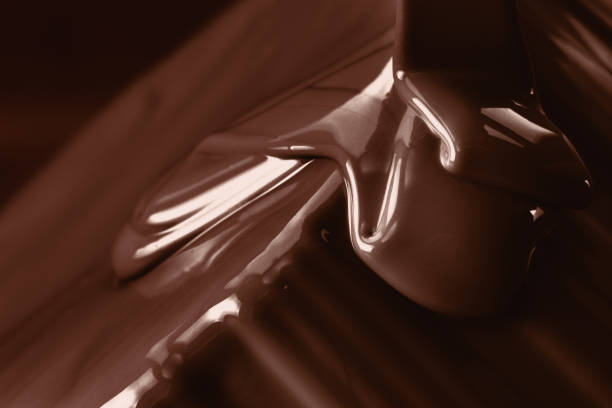 istock Pouring liquid hot chocolate closeup. Cooking dessert. 674793558