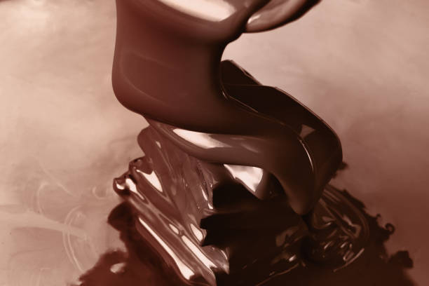 istock Pouring liquid hot chocolate closeup. Cooking dessert. 674793560