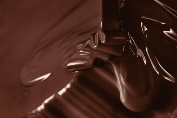 Pouring liquid hot chocolate closeup. Cooking dessert.