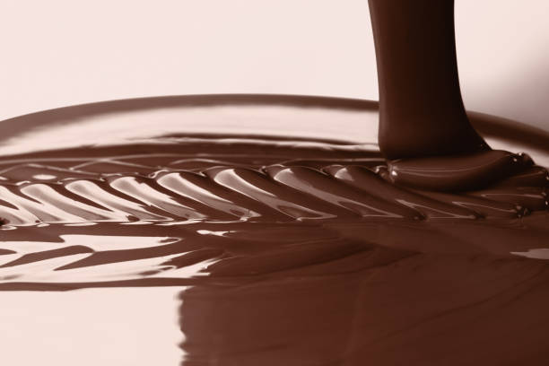 istock Pouring liquid hot chocolate closeup. Cooking dessert. 674793594