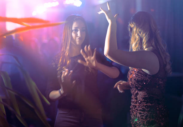 istock Dancing teens enjoying night in club 674799624