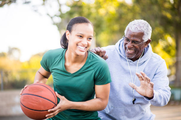 istock Father and Daughter Playing Basketball 674803490