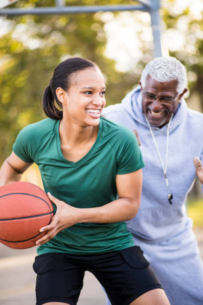istock Father and Daughter Playing Basketball 674803500