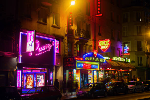 sex shops at Pigalle, Paris, at night Paris, France - October 20, 2016: sex shops at Pigalle district with unidentified people. Pigalle is famous for many sex shops, theatres and adult shows on Place Pigalle and the main boulevards place pigalle stock pictures, royalty-free photos & images