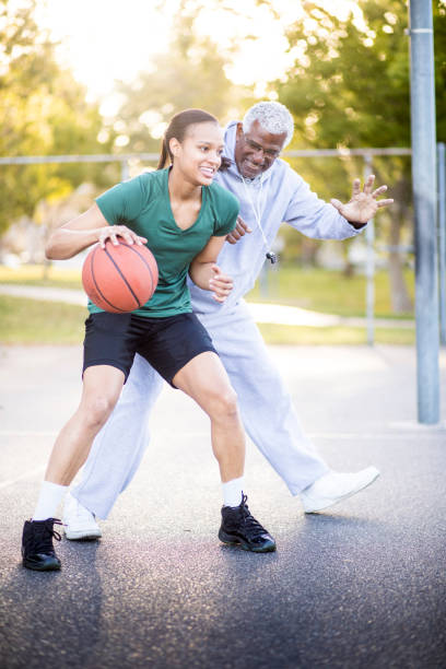 istock Father and Daughter Playing Basketball 674806396