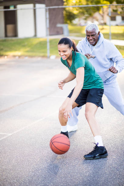 istock Father and Daughter Playing Basketball 674806430