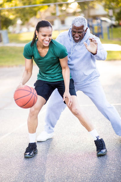 istock Father and Daughter Playing Basketball 674806432