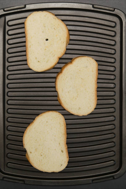 istock three slices of white bread is grilled 674807010