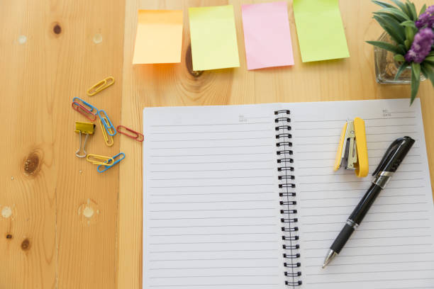 istock Wooden table with office supplies, top view 674807156