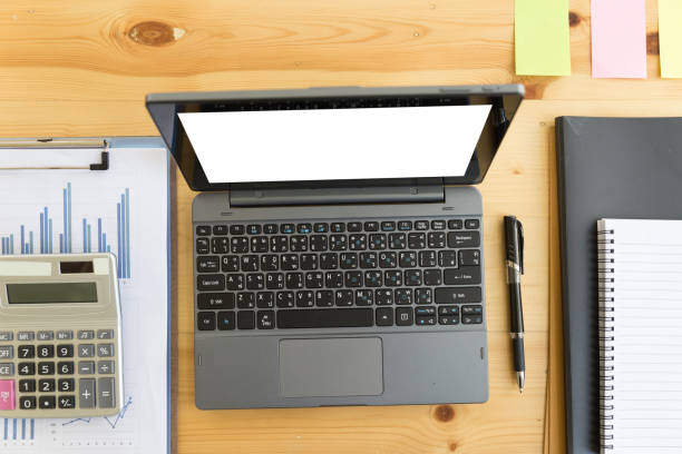 istock Wooden table with office supplies, top view 674807190