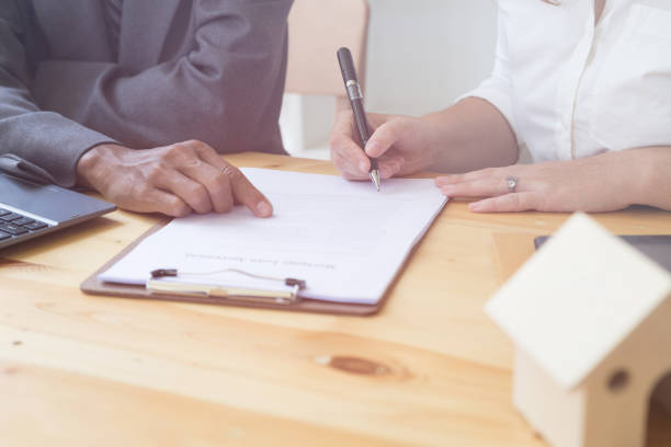 istock Person's hand hold ballpoint pen writing on  agreement paper sheet, fill in document template, applying for mortgage loan 674807226