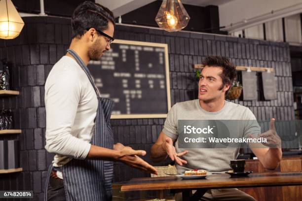 Waiter And Customer Having A Discussion Stock Photo - Download Image Now - Anger, Customer, Restaurant