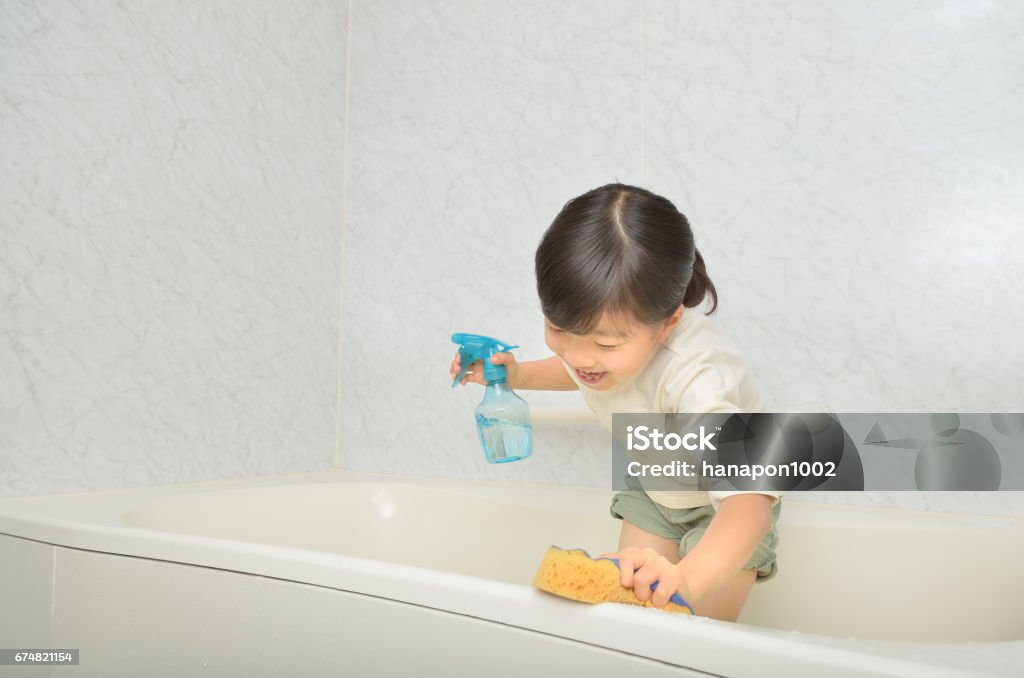Girl cleaning bath Bathtub Stock Photo