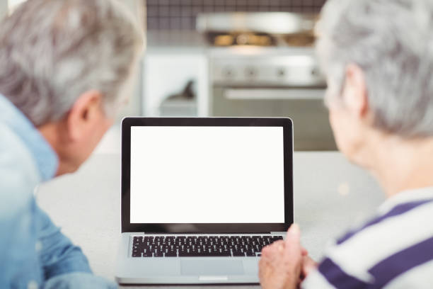 istock Rear view of senior couple using laptop 674821156