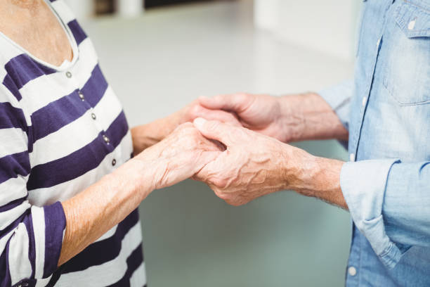 istock Midsection of senior couple holding hands 674821350
