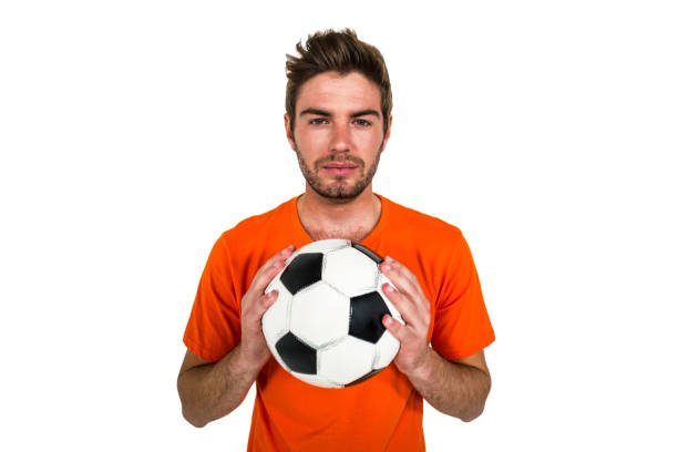 istock Handsome supporter holding football ball 674821402