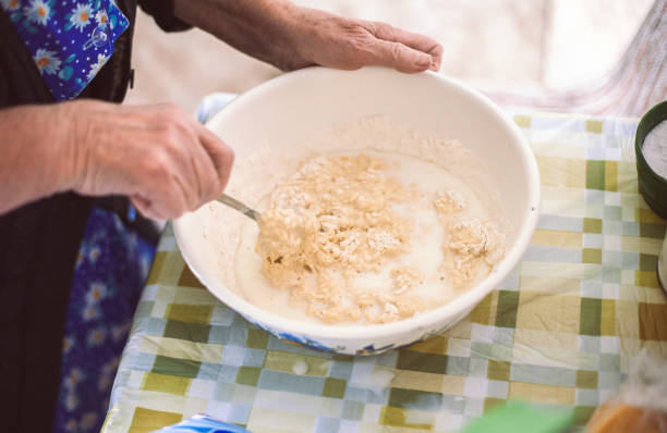 istock Grandmother preparing batter for pancakes 674824654
