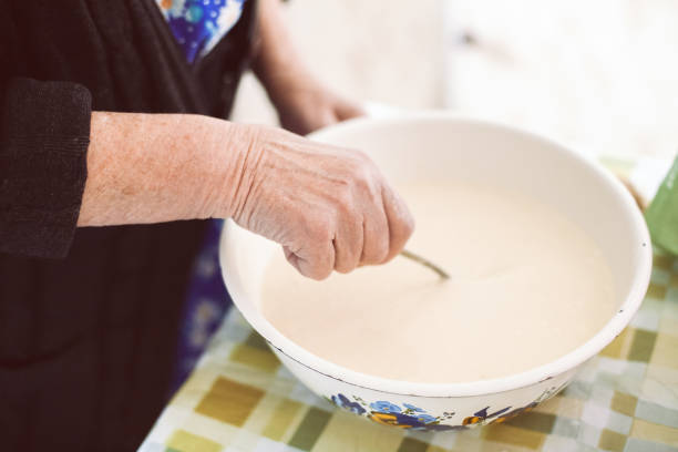 istock Grandmother mixing batter for pancakes 674826782