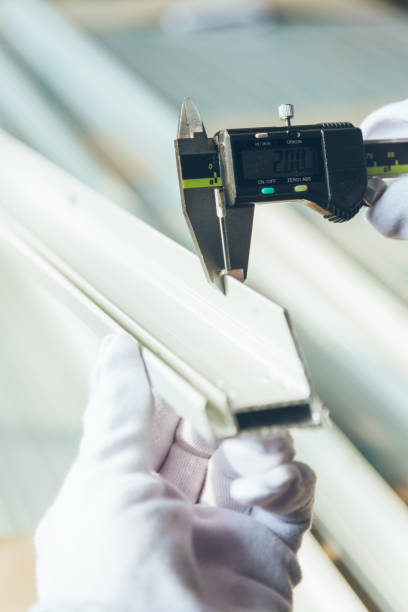 istock worker measuring aluminum product with vernier caliper 674828034